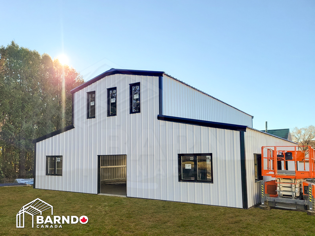 White steel building with tall central roof, shown as equestrian building inspiration