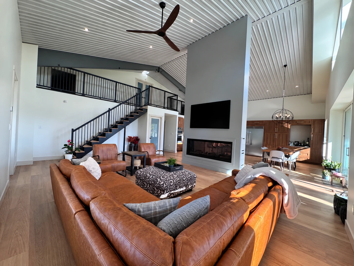Fort Erie living room with a double-sided fireplace, open kitchen and mezzanine