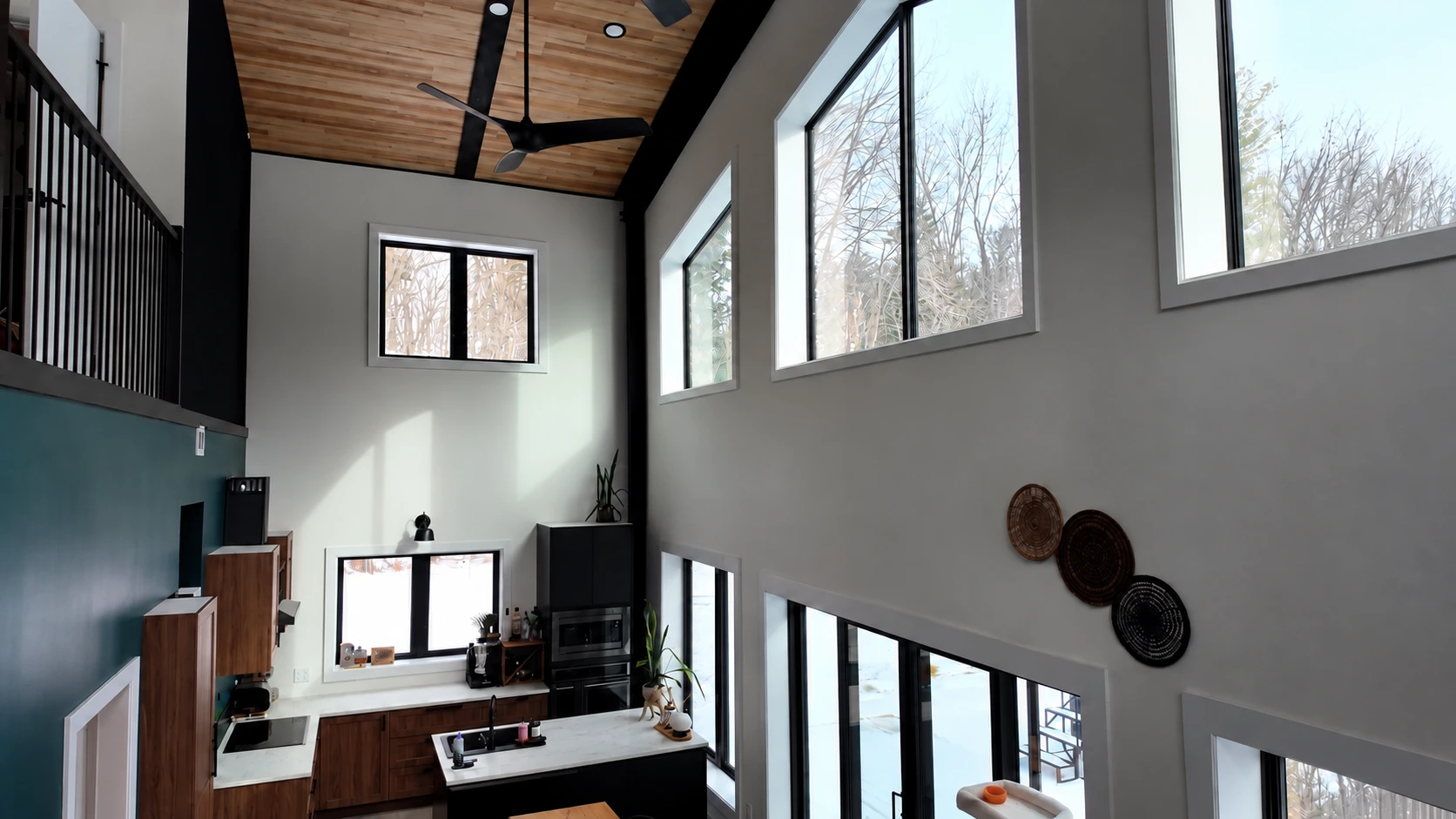Strathroy double-height interior with a timber ceiling, black steel beams, kitchen and loft
