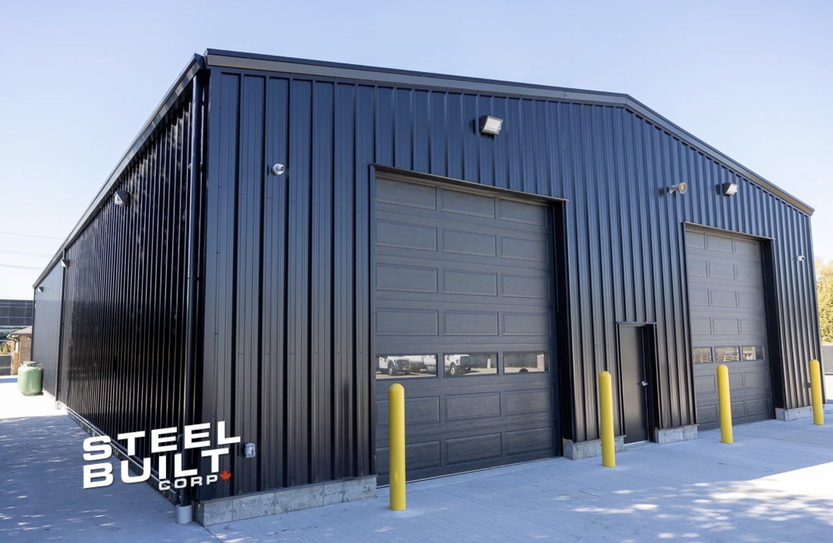 Steel workshop with overhead access doors